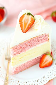 a slice of strawberry cake on a plate with strawberries