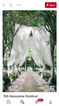 an image of a wedding ceremony with flowers and white draping on the aisle