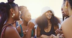 group of women laughing together at an outdoor event