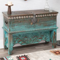 an old trunk is sitting on the floor in front of a wall with a clock above it