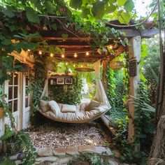 a hammock bed is surrounded by greenery