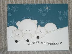 a card with three polar bears in the snow