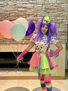 a woman dressed in colorful clothing and balloons