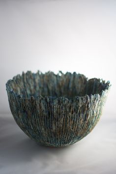 a blue bowl sitting on top of a white table