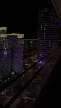 the city lights shine brightly at night in this view from a high rise apartment building