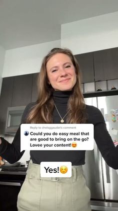 a woman standing in front of a refrigerator holding a sign that says, could you do easy mean that?