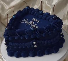 a blue birthday cake sitting on top of a table