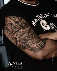 a man with a tattoo on his arm and arms is holding onto another person's shoulder