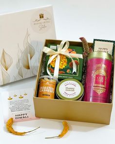 an open gift box filled with different types of body care products next to a greeting card