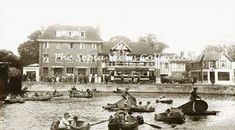 an old black and white photo of people in boats