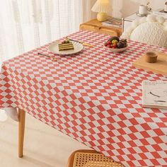 a red and white checkered table cloth on a dining room table