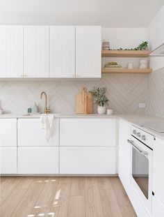 the kitchen is clean and ready for us to use it's white cabinetry