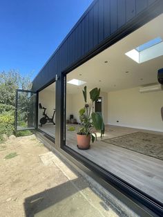 a house with large windows and a potted plant