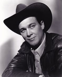 a black and white photo of a man wearing a cowboy hat