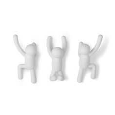 three small plastic figurines in the shape of cats and dogs, one is reaching up