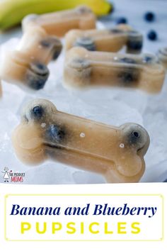 bananas and blueberry popsicles are on ice with banana slices in the background,