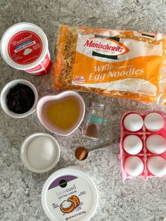 an assortment of ingredients for making muffins on a counter top, including eggs and yogurt