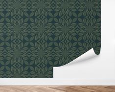 a green wallpaper with an intricate design on it