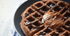 a waffle topped with chocolate sauce on a plate