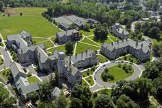 an aerial view of a large building surrounded by trees