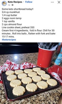 some cookies are on a baking sheet with red and white napkins next to it