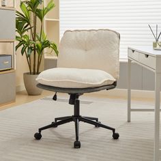 an office chair with a pillow on top of it in front of a computer desk