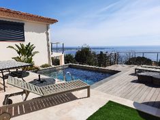 an outdoor swimming pool next to a deck