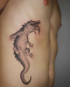 an image of a lizard tattoo on the stomach