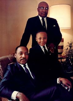 two men sitting next to each other on a couch