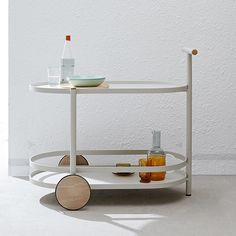 a white serving cart with drinks on it