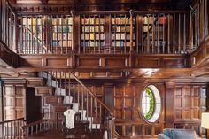 an old library with wooden walls and stairs