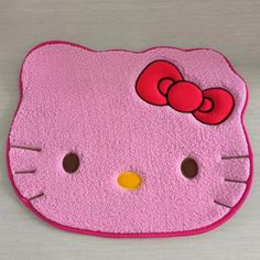 a pink hello kitty rug on a table