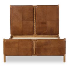 a bed with two brown leather headboards on top of it