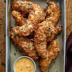 chicken wings with dipping sauce on a tray