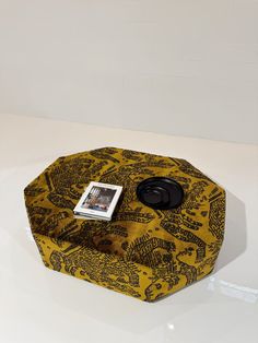 a yellow and black box with a magazine on it sitting on a white counter top