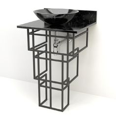 a black sink sitting on top of a metal stand