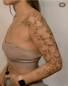 a woman with tattoos on her arm and shoulder