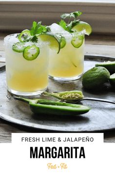 fresh lime and jalapeno margaritas on a metal tray with green peppers