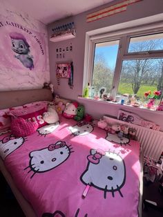 a bedroom with hello kitty bedding and pink walls