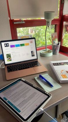 an open laptop computer sitting on top of a wooden desk