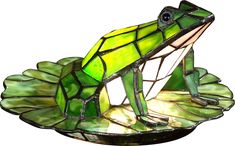 A handsome prince in disguise, the frog in the fanciful Odette Grove lamp is so life like he appears to be ready to leap off his lily pad and into a pond. Art glass in various shades of green, white and yellow make up this three dimensional frog sitting on a glass lily pad base. Whether you are a princess at heart or just looking to add a whimsical touch to your home, this delightful little accent lamp is for you. Partial assembly may be required. Stained Glass Frog, Frog Lily Pad, Frog Decor, Tiffany Art, Glass Frog, Tiffany Lamps, Arte Inspo, Antique Lamps, Tiffany Style