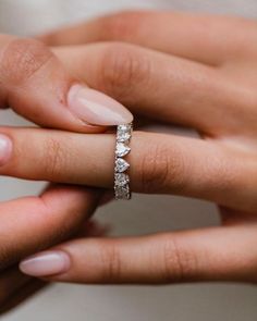 a woman's hand with a wedding ring on her finger