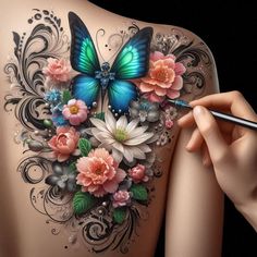 a woman's back with flowers and butterflies painted on her body, holding a pencil