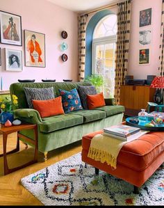 a living room filled with lots of furniture and pictures on the wall above it's windows