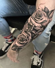 a man with a rose tattoo on his arm