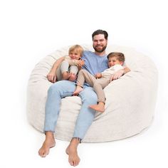 a man and two children sitting on a bean bag chair