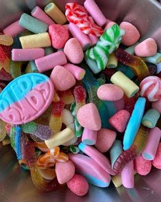 a metal bowl filled with lots of candy