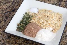 an assortment of spices and seasonings on a square white plate sitting on a granite countertop