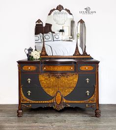 an antique dresser with a mirror on top