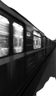 a black and white photo of a train passing by